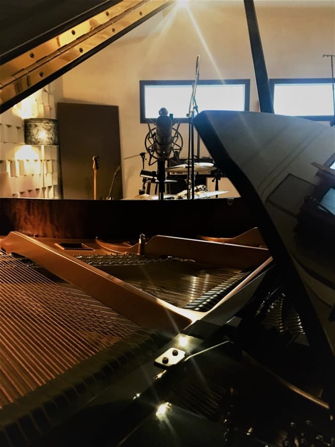 Grand piano lit by daylight in the B-Note live room