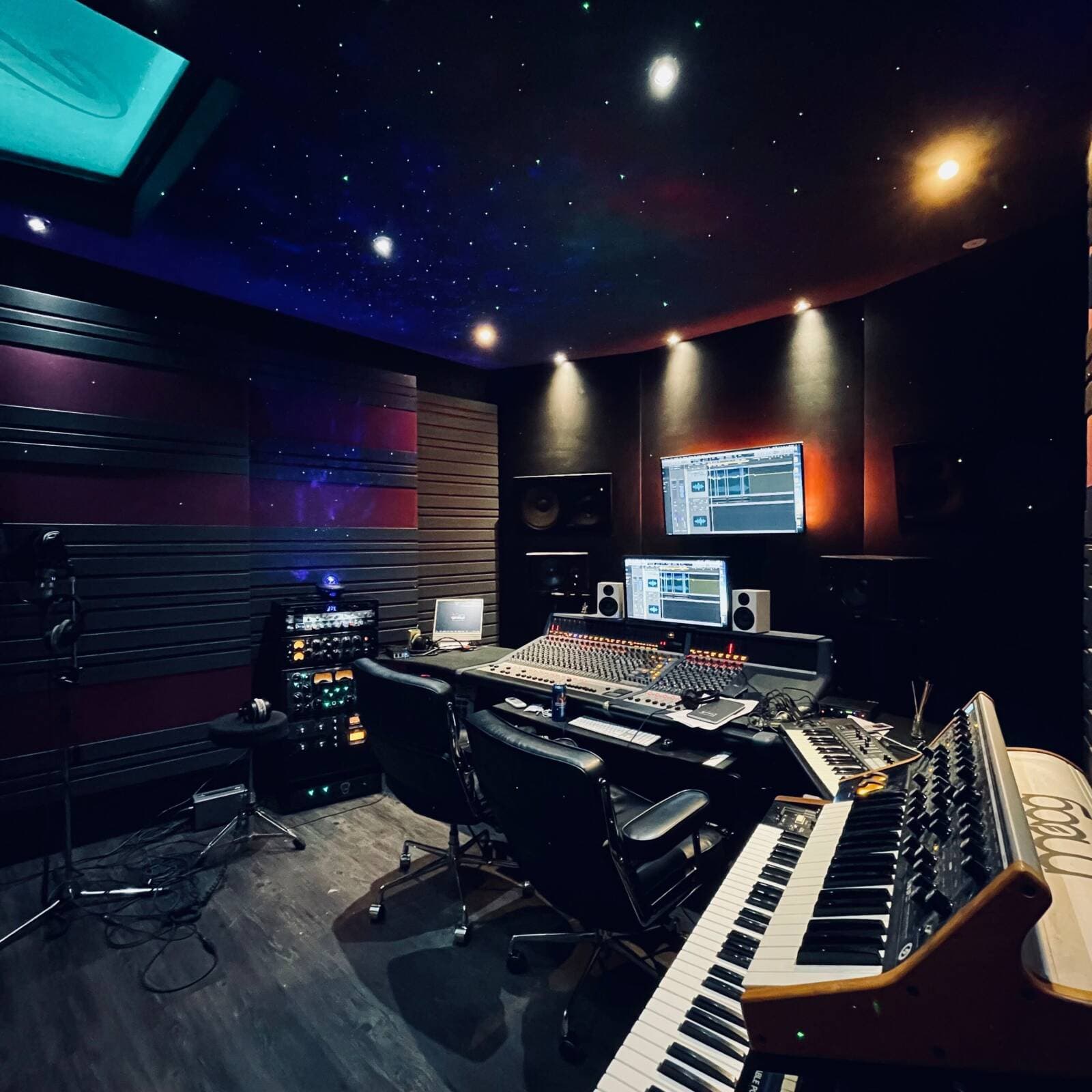 The B-Note control room under its star-field ceiling, with the mixing console, studio monitors and analog keyboards